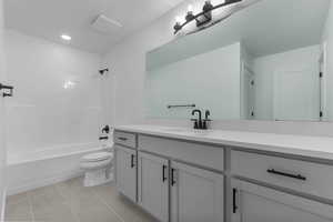 Bathroom with vanity, shower / washtub combination, and light tile patterned floors