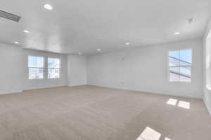 Unfurnished room featuring light colored carpet and recessed lighting