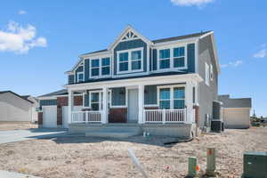 View of front facade with board and batten siding, a porch, concrete driveway, an attached garage, and a shingled roof