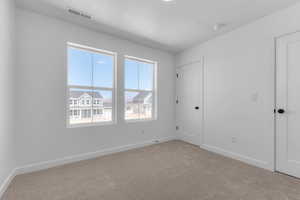 Unfurnished bedroom featuring baseboards and carpet flooring