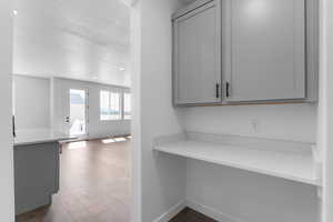 Hallway with dark wood-style floors, a textured ceiling, and recessed lighting