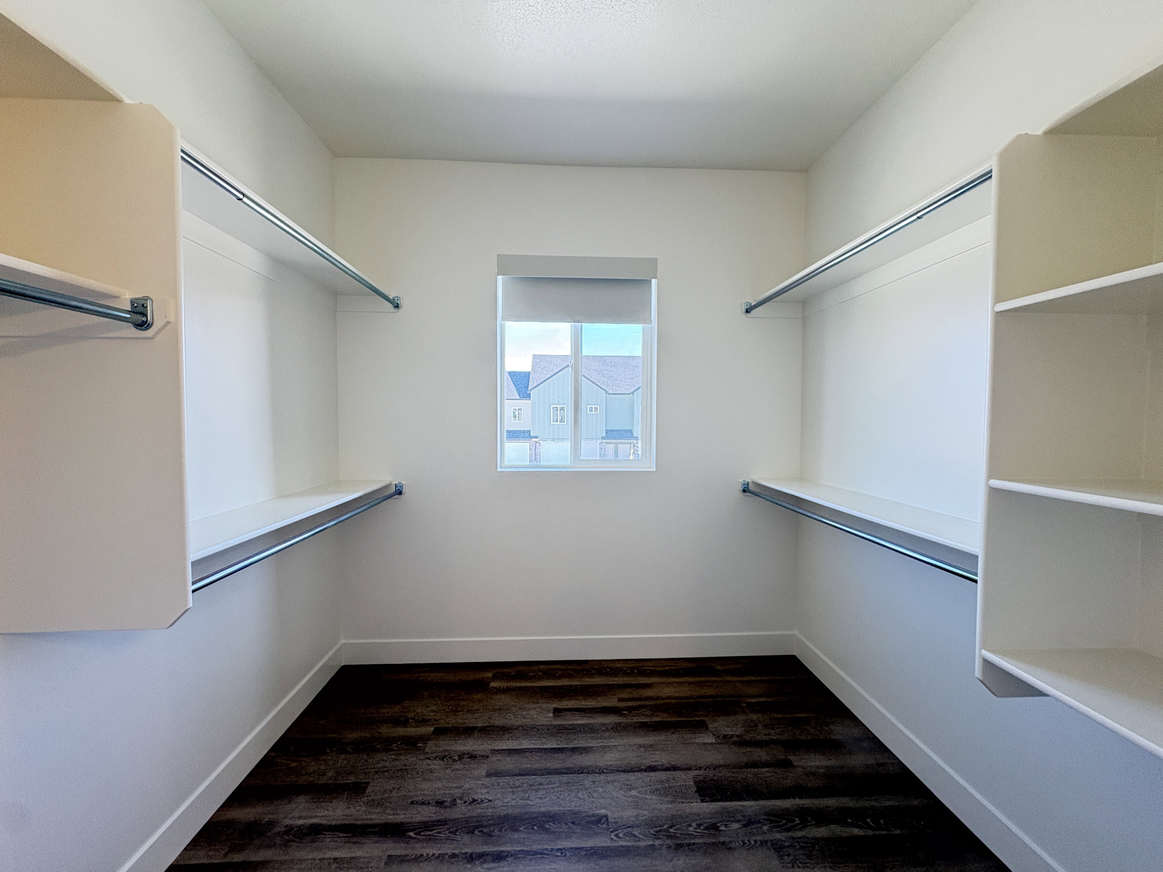 Walk in closet featuring dark wood-style flooring