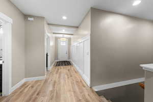 Hall featuring light wood-style floors and recessed lighting