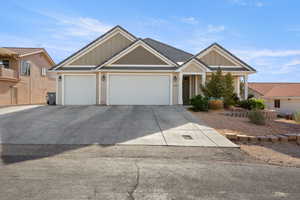 Craftsman-style house with board and batten siding, a garage, and concrete driveway