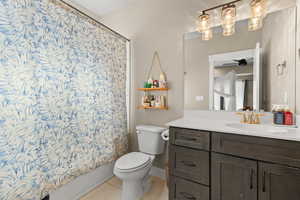 Full bath featuring vanity, shower / tub combo, and light tile patterned floors