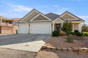 Craftsman house featuring board and batten siding, an attached garage, and driveway