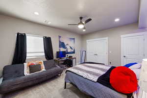 Bedroom with a closet, carpet, a ceiling fan, and recessed lighting