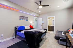 Bedroom with light carpet, a ceiling fan, ensuite bath, and recessed lighting