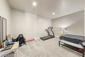 Workout area featuring light carpet and recessed lighting