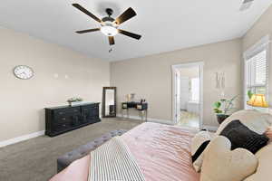 Bedroom with carpet flooring, a ceiling fan, and ensuite bathroom