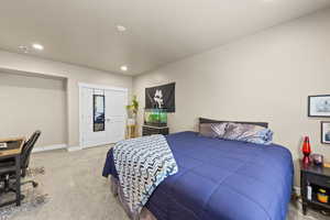 Carpeted bedroom featuring a desk and recessed lighting