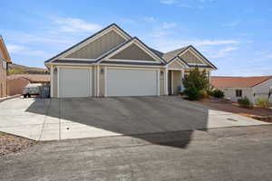 Craftsman house featuring board and batten siding, a garage, and concrete driveway