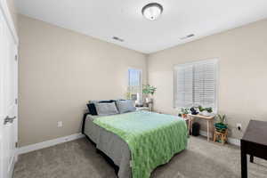Bedroom featuring carpet flooring and baseboards