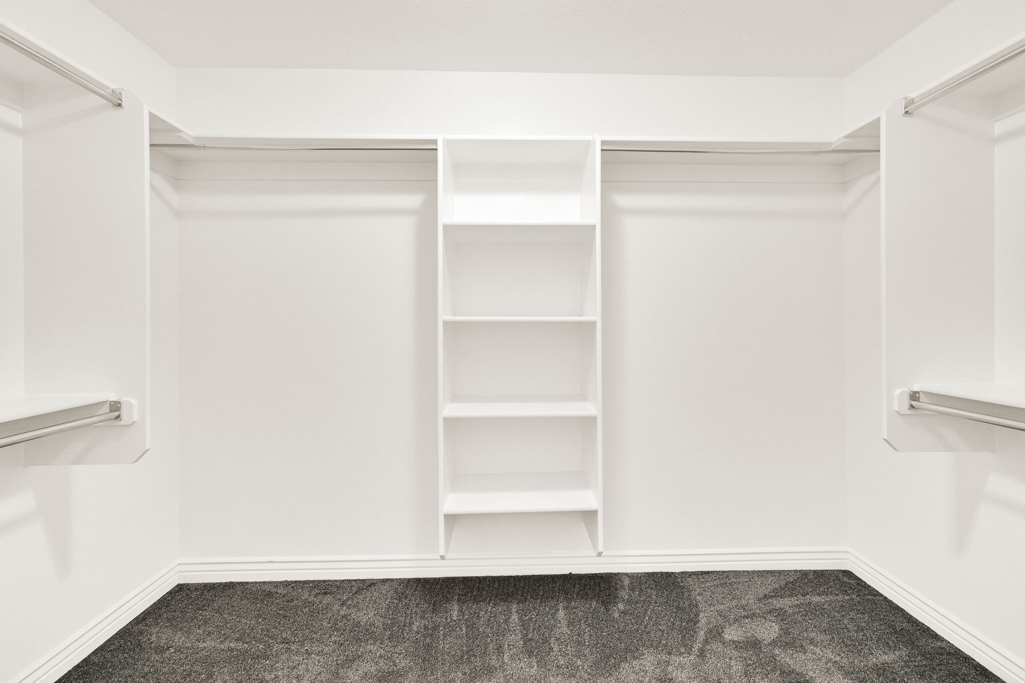 Walk in closet featuring dark colored carpet