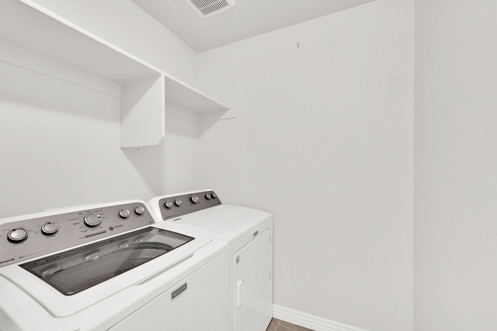 Laundry room featuring baseboards and washer and clothes dryer