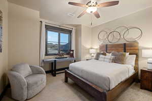 Bedroom featuring ceiling fan and light carpet