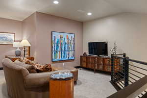Living area featuring recessed lighting and light carpet