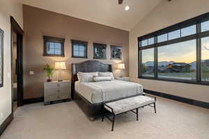Bedroom featuring vaulted ceiling, recessed lighting, light carpet, and a mountain view