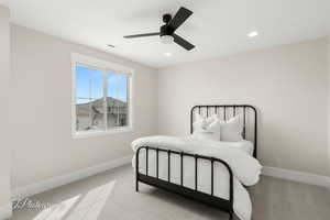 Bedroom featuring light carpet, a ceiling fan, and recessed lighting