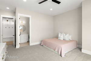 Bedroom featuring light colored carpet, a ceiling fan, recessed lighting, and connected bathroom