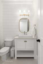 Half bathroom featuring vanity and light tile patterned floors