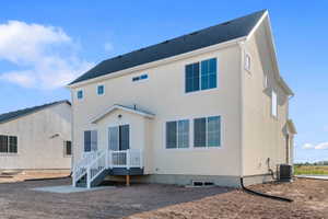 Contemporary residence featuring a light-colored stucco exterior, dark shingle roof, and white-framed windows