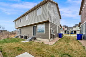Back of property with a lawn