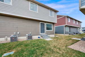 Back of house with a yard