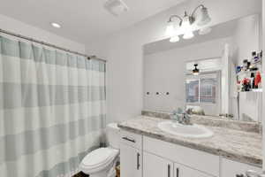 Bathroom featuring ensuite bathroom, vanity, a shower with shower curtain, recessed lighting, and ceiling fan