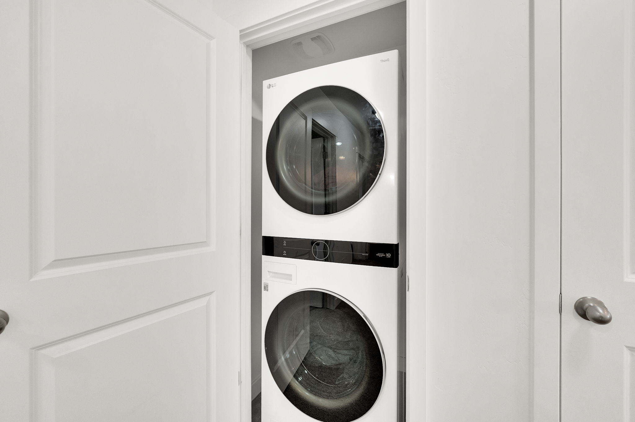 Laundry area with stacked washer / dryer