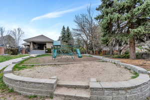 Community jungle gym with a patio area