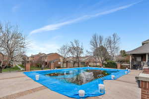 Community pool featuring a residential view and a patio