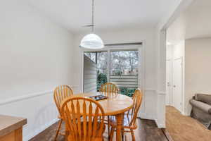 Dining room featuring dark wood-type flooring and baseboards