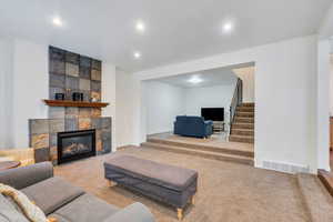 Living area featuring a fireplace, carpet flooring, and recessed lighting