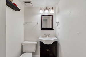 Bathroom featuring vanity and toilet