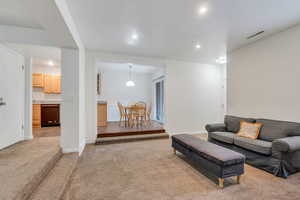 Living area featuring recessed lighting and light carpet