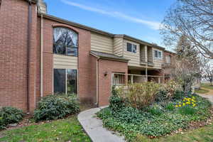 View of side of home with brick siding