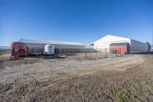 View of yard with a pole building, an outbuilding, and a garage
