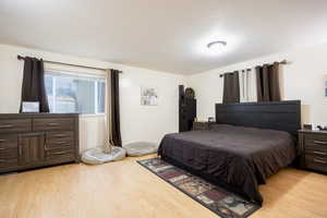 Bedroom with light wood-style floors