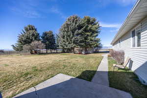 Fenced backyard with an outbuilding
