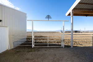 View of yard with an outbuilding, a mountain view, and an exterior structure