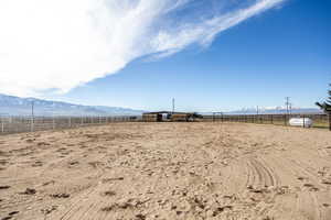 View of yard featuring a mountain view, an enclosed horse arena, and a rural view