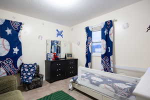 Bedroom featuring light colored carpet