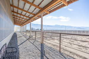 View of yard featuring an outbuilding, an exterior structure, and a mountain view