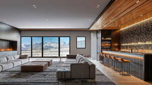 Living area with a mountain view, light wood-style flooring, and a community bar