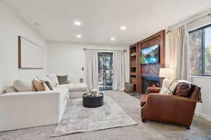 Carpeted living room with fireplace