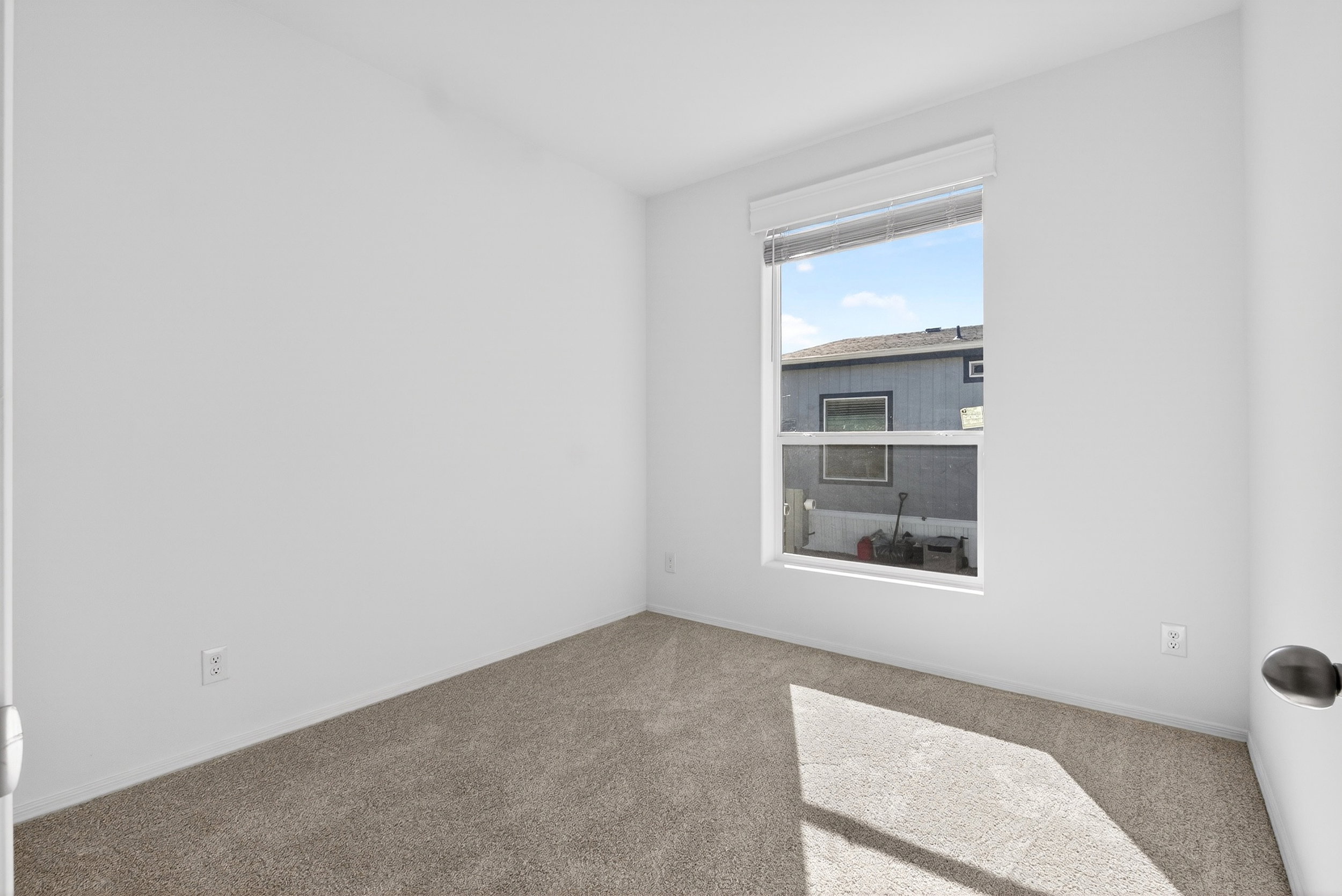 Carpeted spare room with baseboards