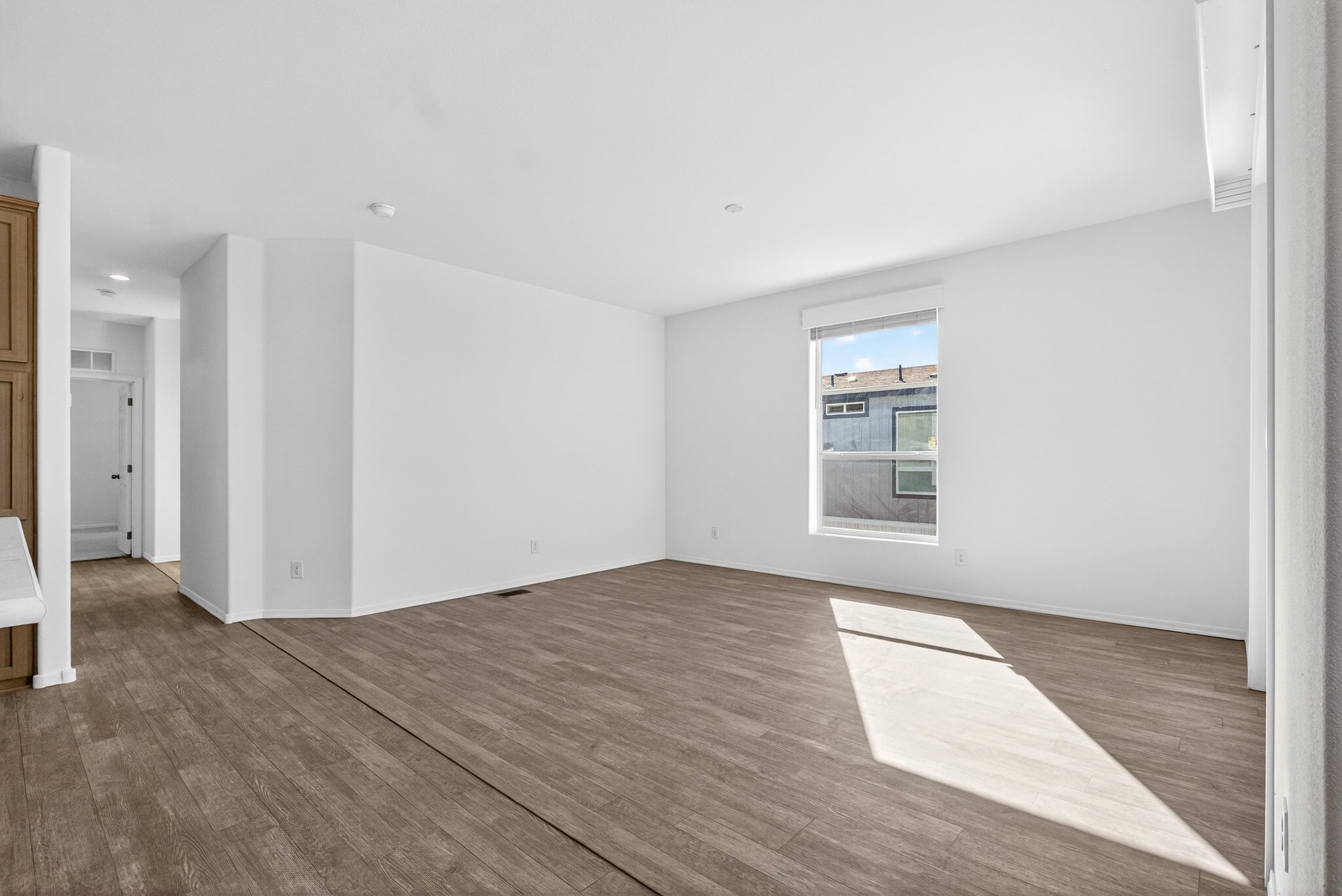 Empty room with dark wood-style floors and baseboards