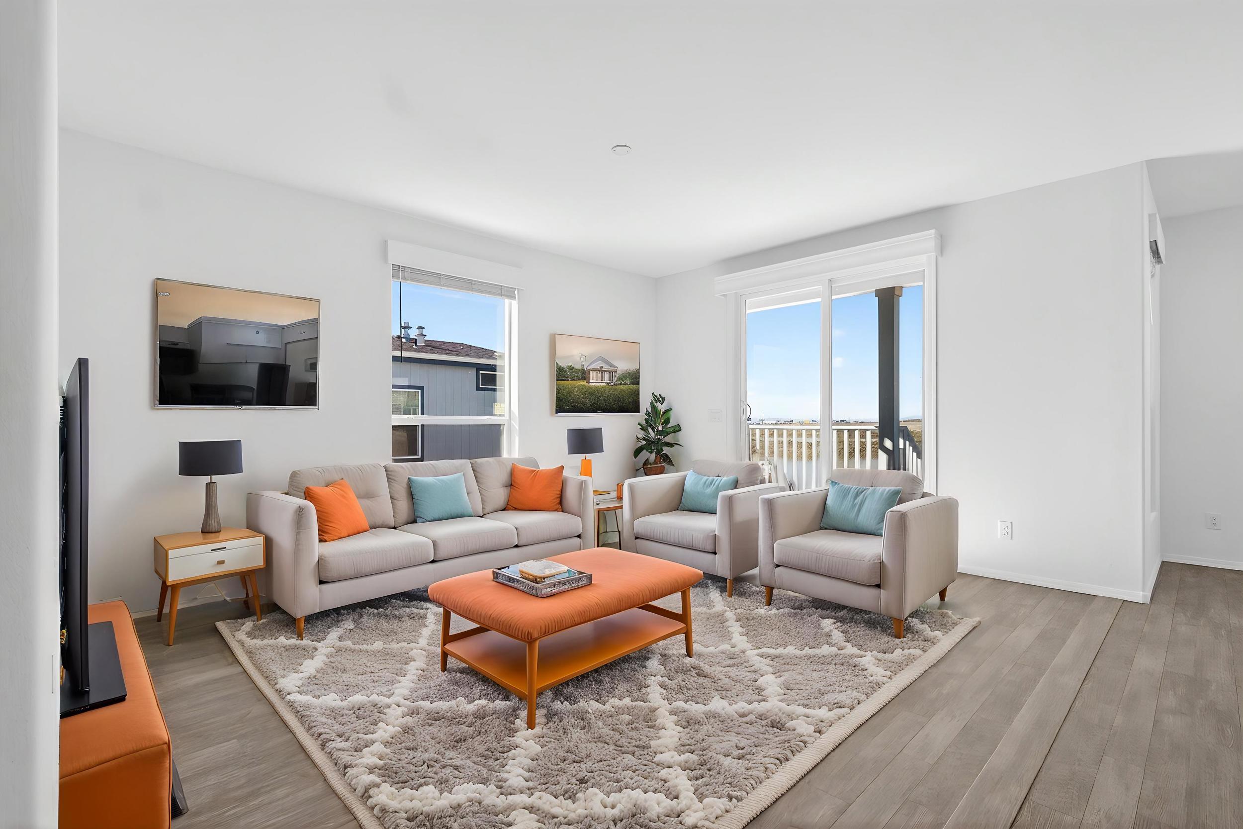 *Virtually Staged* Living room featuring healthy amount of natural light and wood finished floors