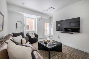 Living room with wood finished floors and baseboards